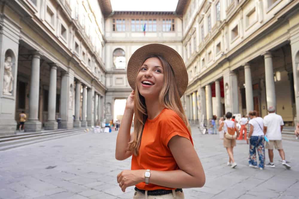 Lachende Frau im Hof des historischen Museums der Uffizien in Florenz, Italien